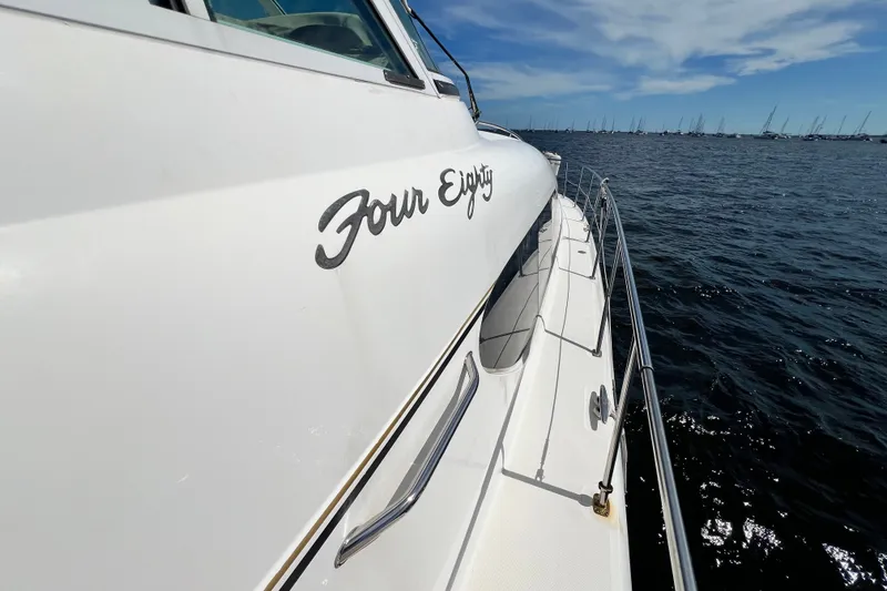 Slide: The Image of 2003 Sea Ray 480 Motor Yacht on open water, side view with "Four Eighty" text. - 188