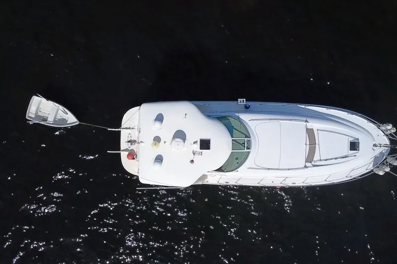 Slide: The Image of Aerial view of 2003 Sea Ray 480 Motor Yacht on dark water. - 197