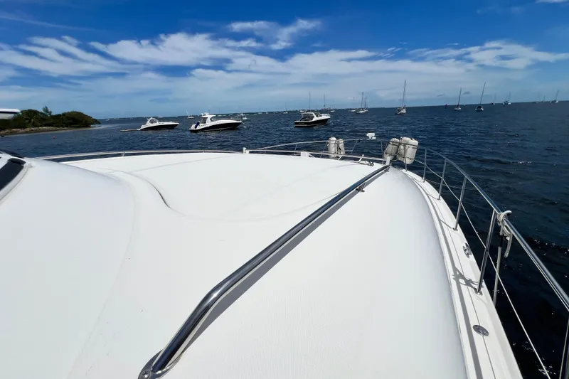Slide: The Image of 2003 Sea Ray 480 Motor Yacht on open water with other boats in the background. - 71