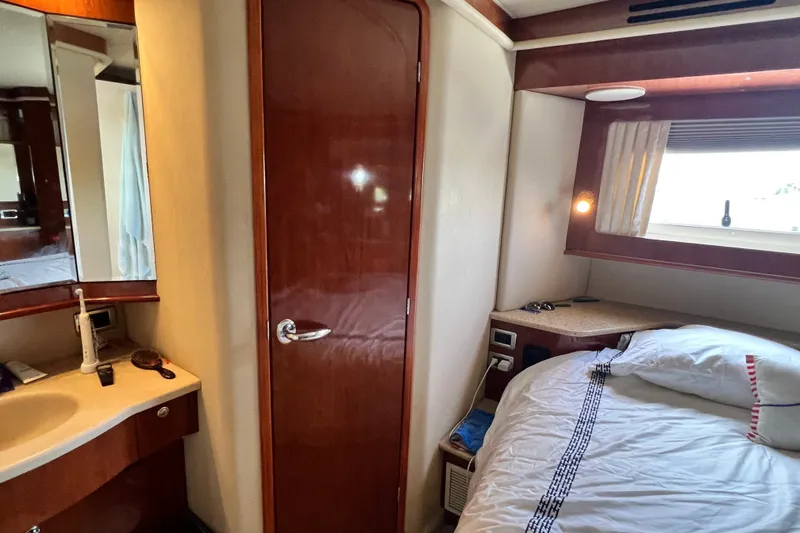 Slide: The Image of Interior of 2003 Sea Ray 480 Motor Yacht cabin with bed and vanity area. - 132
