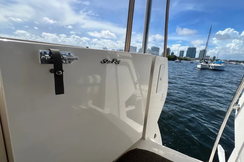 Slide: The Image of 2003 Sea Ray 480 Motor Yacht on water with city skyline in background. - 191