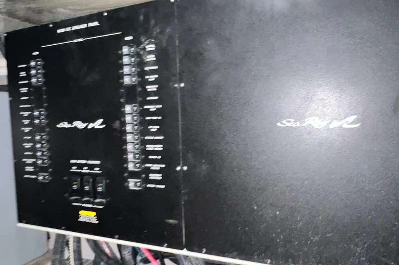 Slide: The Image of Electrical panel of a 2003 Sea Ray 480 Motor Yacht, featuring control switches and wiring. - 46