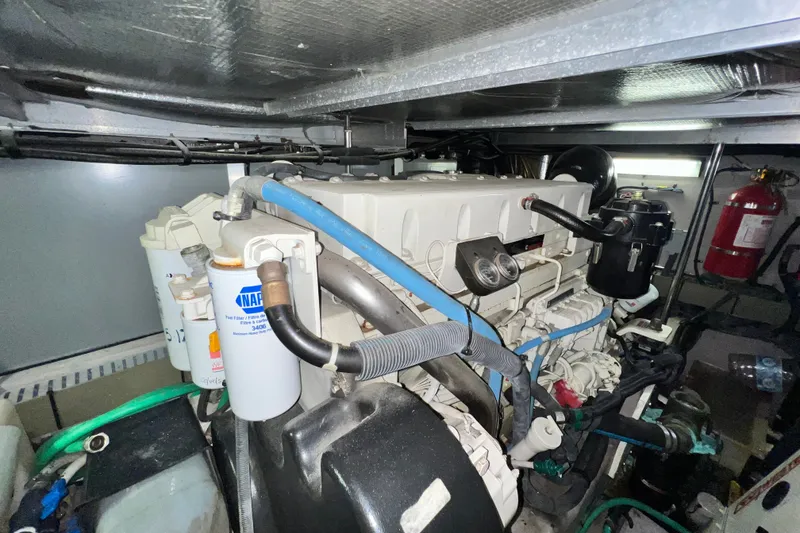 Slide: The Image of Engine room of a 2003 Sea Ray 480 Motor Yacht with visible components and fire extinguisher. - 33