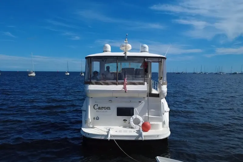 Slide: The Image of 2003 Sea Ray 480 Motor Yacht on open water with clear blue sky. - 8