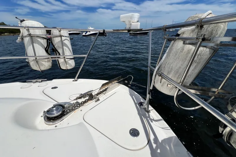 Slide: The Image of Bow of 2003 Sea Ray 480 Motor Yacht with anchor and life rings on a sunny day. - 65