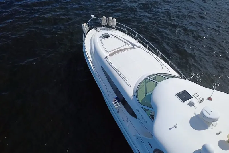 Slide: The Image of Aerial view of 2003 Sea Ray 480 Motor Yacht cruising on open water. - 212