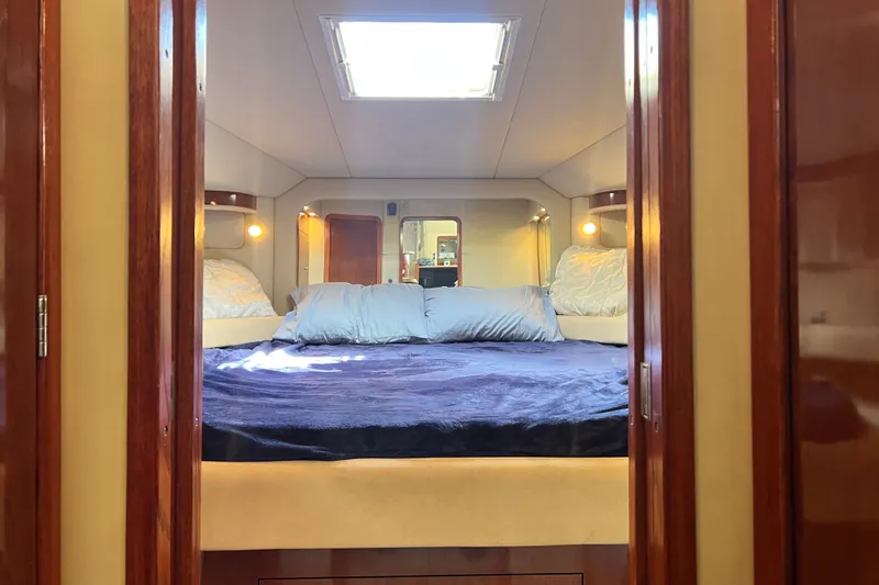 Slide: The Image of Luxurious bedroom interior of 2003 Sea Ray 480 Motor Yacht with plush bedding. - 105