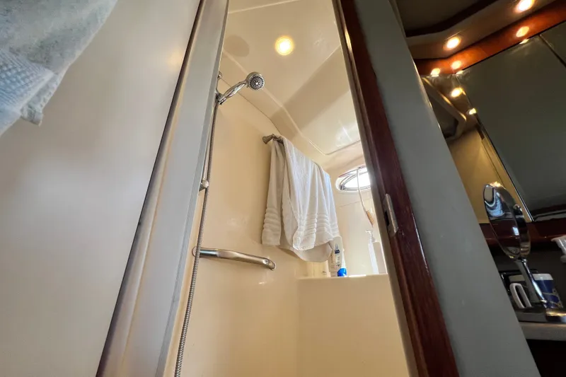 Slide: The Image of Shower area inside a 2003 Sea Ray 480 Motor Yacht, featuring modern fixtures and lighting. - 136