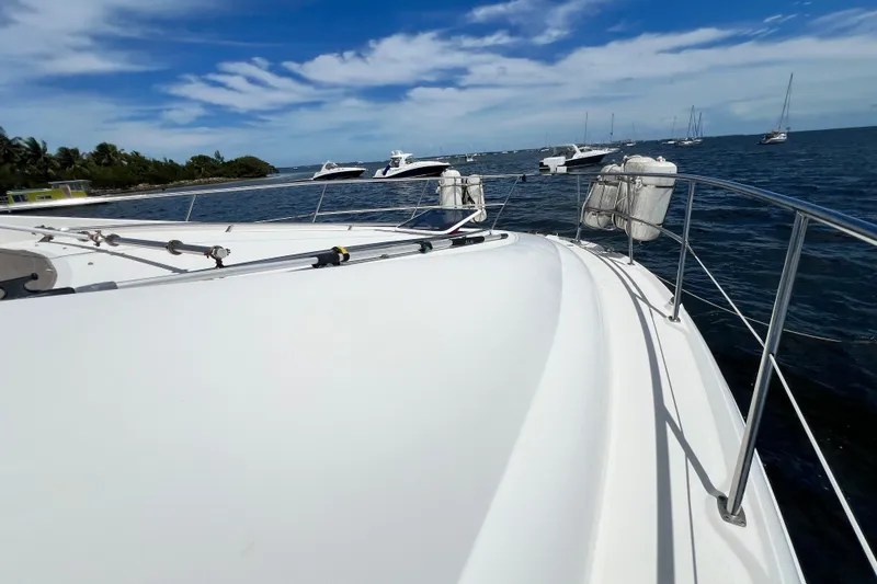 Slide: The Image of 2003 Sea Ray 480 Motor Yacht on calm waters under a clear blue sky. - 68