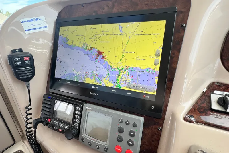 Slide: The Image of Garmin navigation system on 2003 Sea Ray 480 Motor Yacht dashboard with communication devices. - 91