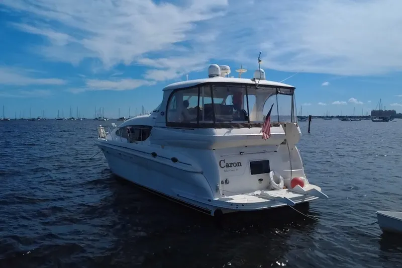 Slide: The Image of 2003 Sea Ray 480 Motor Yacht on calm waters under a clear blue sky. - 9