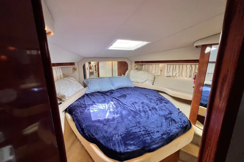 Slide: The Image of Luxurious bedroom interior of 2003 Sea Ray 480 Motor Yacht with plush bedding. - 104