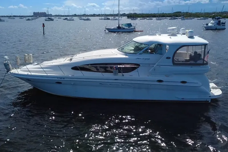 Slide: The Image of 2003 Sea Ray 480 Motor Yacht on calm waters, surrounded by other boats. - 10