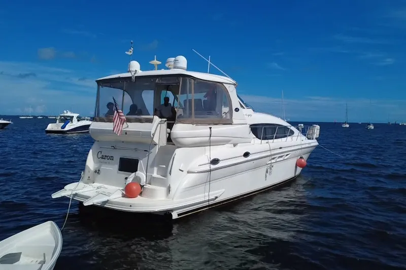 Slide: The Image of 2003 Sea Ray 480 Motor Yacht on calm blue waters, rear view. - 7