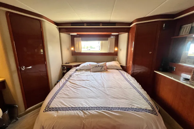 Slide: The Image of Luxurious bedroom interior of 2003 Sea Ray 480 Motor Yacht with elegant wood finishes. - 140