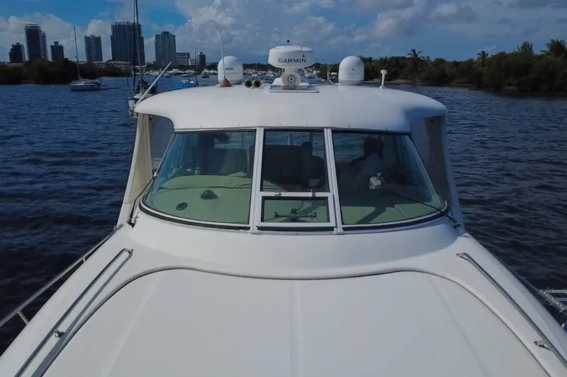 Slide: The Image of 2003 Sea Ray 480 Motor Yacht cruising on a scenic waterway with city skyline. - 201