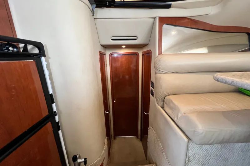 Slide: The Image of Interior hallway of 2003 Sea Ray 480 Motor Yacht with wooden doors and beige upholstery. - 99