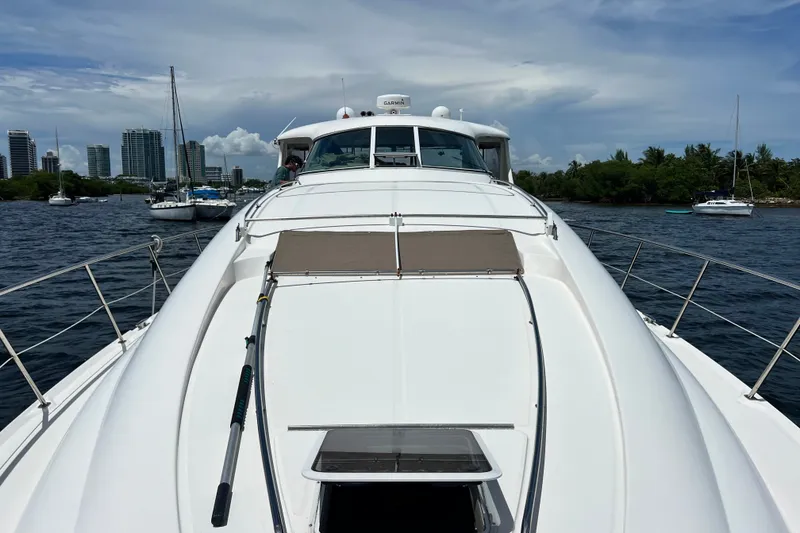 Slide: The Image of 2003 Sea Ray 480 Motor Yacht cruising on a scenic waterway with city skyline. - 74