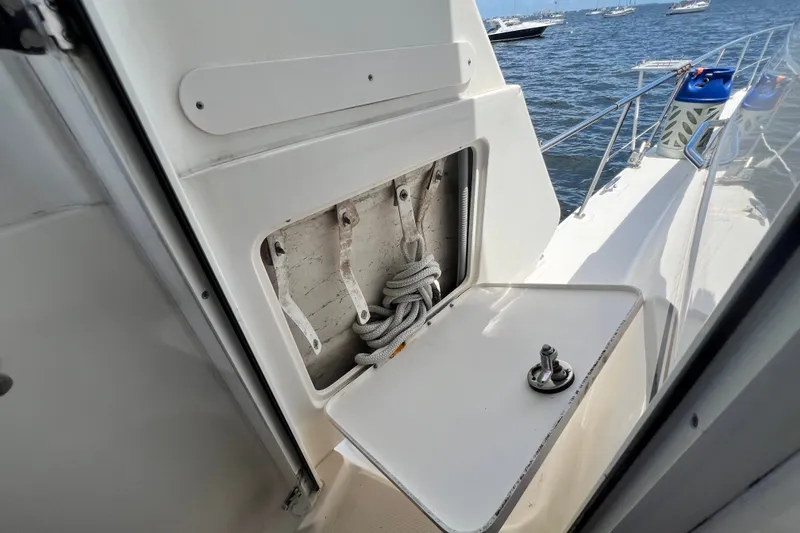 Slide: The Image of 2003 Sea Ray 480 Motor Yacht deck with storage compartment and ocean view. - 83