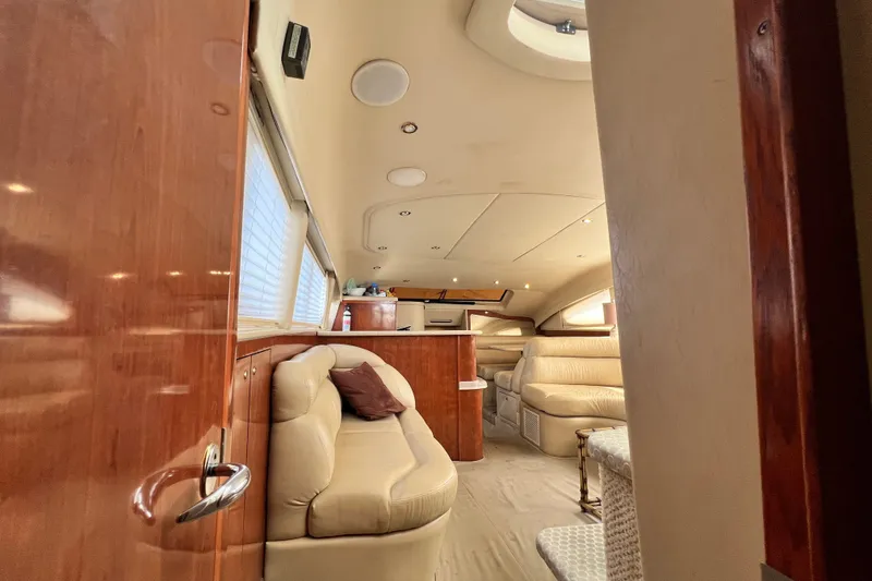Slide: The Image of Luxurious interior of 2003 Sea Ray 480 Motor Yacht with plush seating and elegant wood finishes. - 161