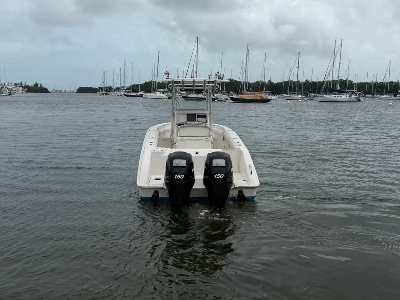 Slide: The Image of A 2006 Boston Whaler 240 Outrage with twin outboard engines on calm water. - 4