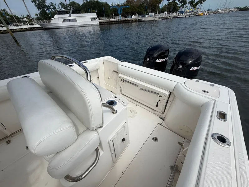 Slide: The Image of The image shows the cockpit of a 2006 Boston Whaler 240 Outrage with two outboard engines. - 9