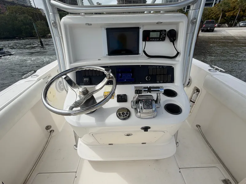 Slide: The Image of The image shows the helm of a 2006 Boston Whaler 240 Outrage with steering wheel and instruments. - 7