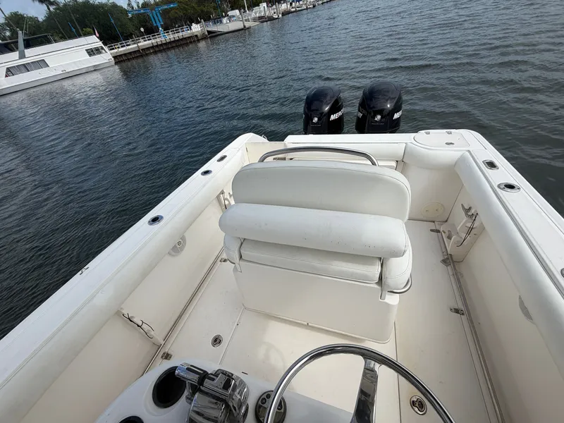 Slide: The Image of The image shows the cockpit of a 2006 Boston Whaler 240 Outrage with twin outboard engines. - 10