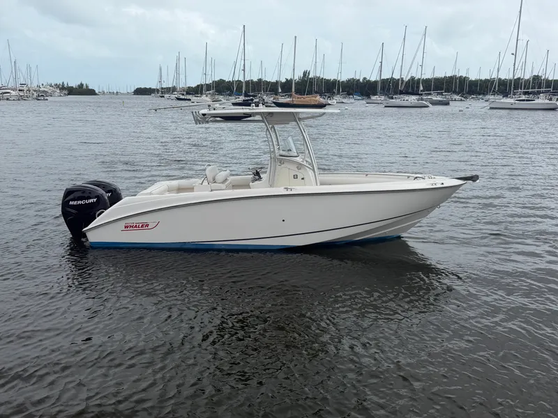 The Image of A 2006 Boston Whaler 240 Outrage on calm water, surrounded by sailboats. - 0