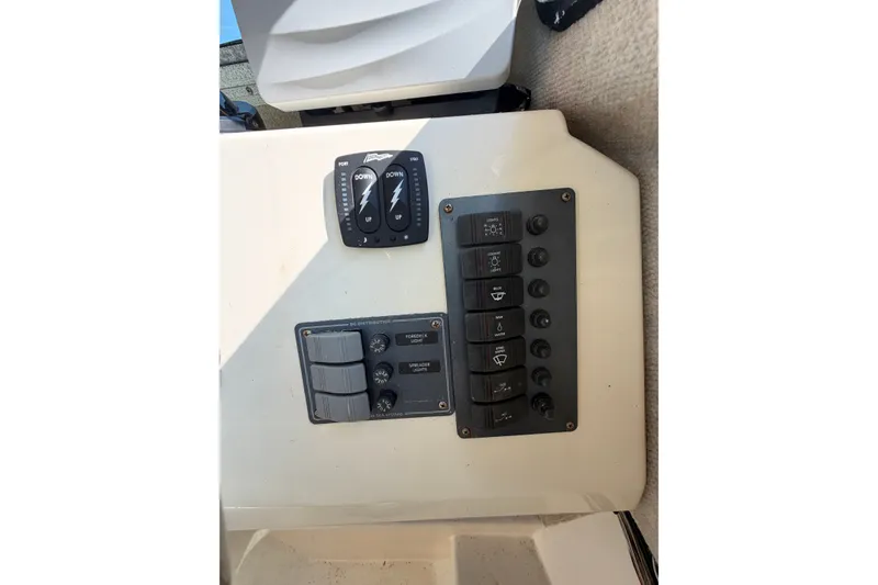 Slide: The Image of Control panel of a 2003 Parker 2120 Sport Cabin boat, featuring various switches and controls. - 20