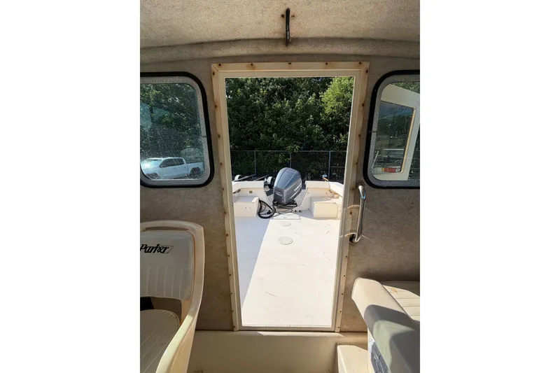 Slide: The Image of Interior view of 2003 Parker 2120 Sport Cabin boat, showing cabin door and seating. - 19