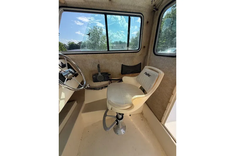 Slide: The Image of 2003 Parker 2120 Sport Cabin interior with steering wheel and captain's chair. - 8