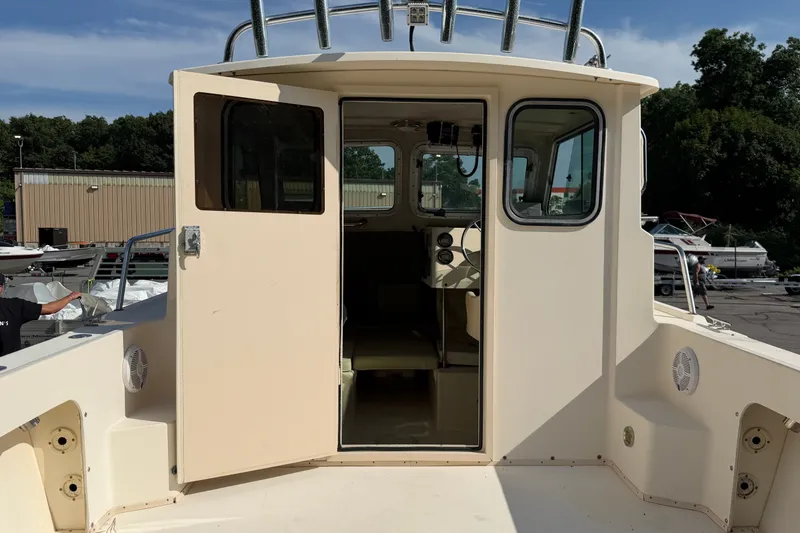 Slide: The Image of The 2003 Parker 2120 Sport Cabin features an open cabin door and helm station. - 5