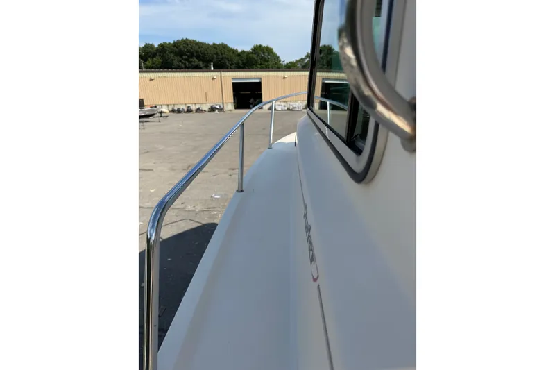 Slide: The Image of 2003 Parker 2120 Sport Cabin boat side view with railing and window. - 14