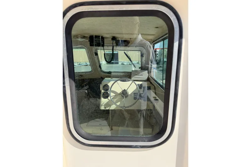 Slide: The Image of Interior view of 2003 Parker 2120 Sport Cabin boat through window. - 15