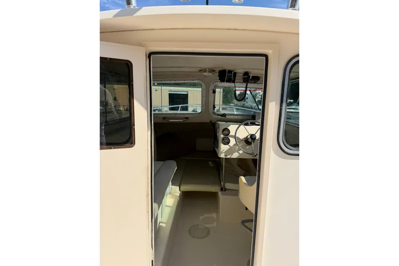 Slide: The Image of 2003 Parker 2120 Sport Cabin interior with steering wheel and seating. - 13