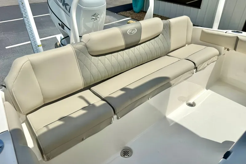 Slide: The Image of 2025 Key West 219 FS boat with beige cushioned seating and Suzuki engine. - 26