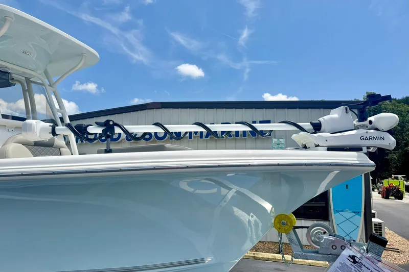 Slide: The Image of 2025 Key West 219 FS boat with Garmin equipment, displayed outdoors under a clear sky. - 9
