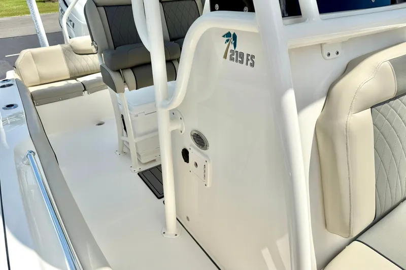 Slide: The Image of 2025 Key West 219 FS boat interior with cushioned seating and sleek design. - 18