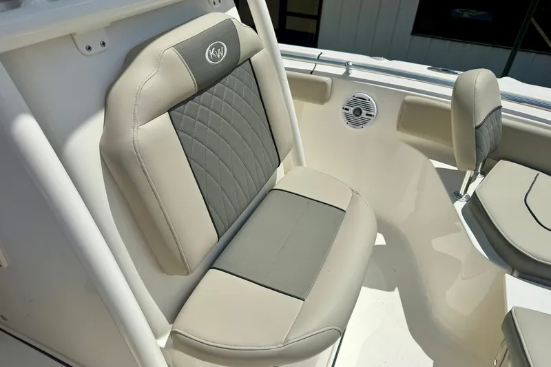 Slide: The Image of 2025 Key West 219 FS boat seat with beige and gray upholstery, featuring KW logo. - 16