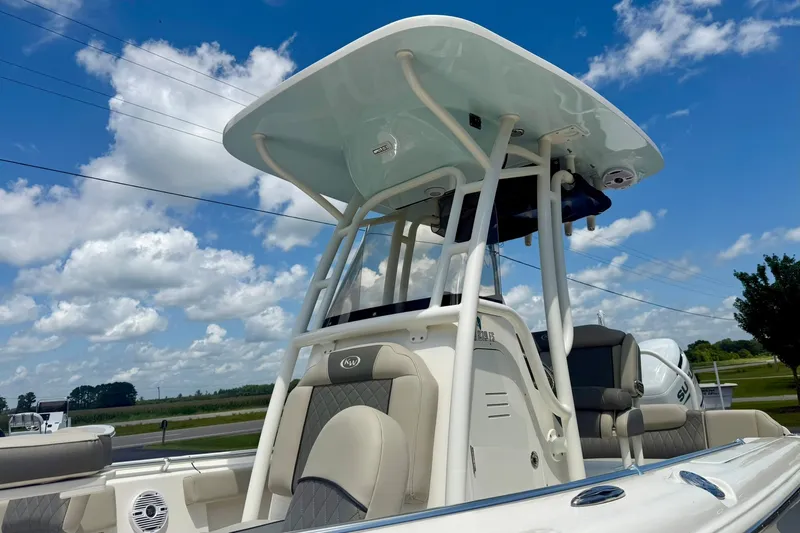 Slide: The Image of 2025 Key West 219 FS boat with T-top under a clear blue sky. - 33