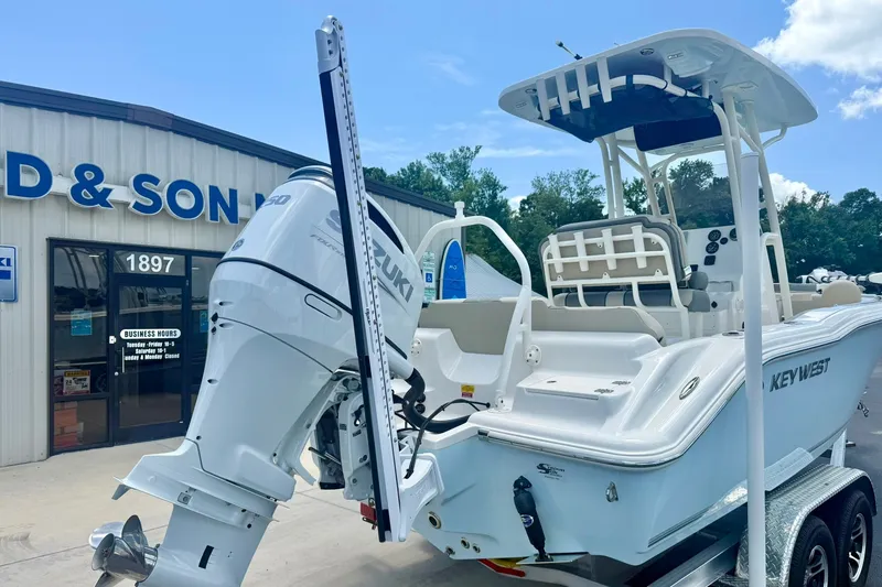 Slide: The Image of 2025 Key West 219 FS boat with Suzuki engine outside dealership. - 35