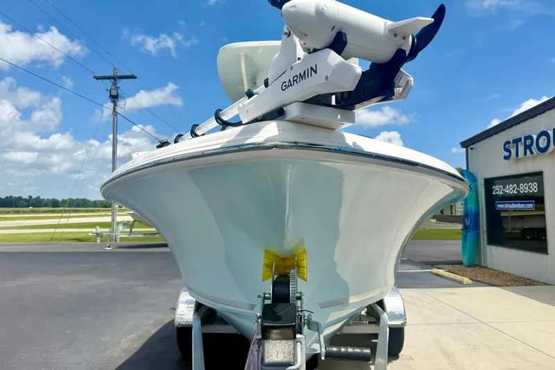 Slide: The Image of 2025 Key West 219 FS boat on trailer, featuring Garmin equipment, under a clear blue sky. - 8