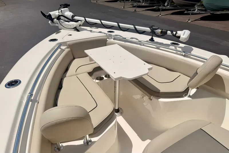 Slide: The Image of 2025 Key West 219 FS boat interior with seating and table setup. - 12