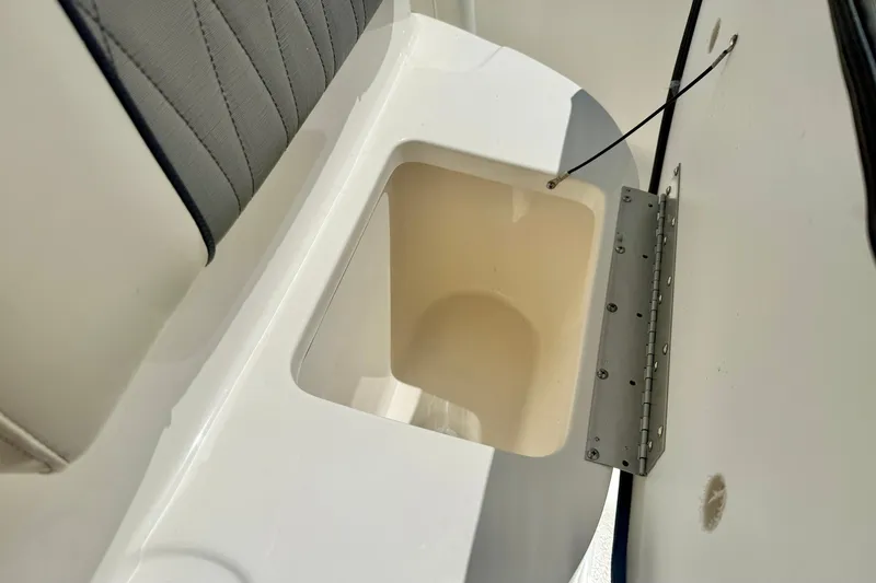 Slide: The Image of Storage compartment on a 2025 Key West 219 FS boat, featuring a hinged lid. - 17