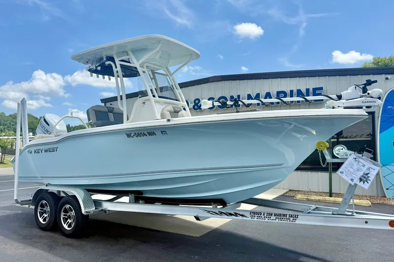 Slide: The Image of 2025 Key West 219 FS boat on trailer at marine dealership. - 4
