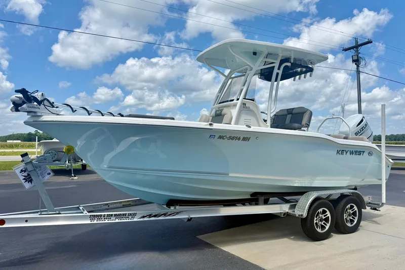 Slide: The Image of 2025 Key West 219 FS boat on trailer under blue sky. - 5