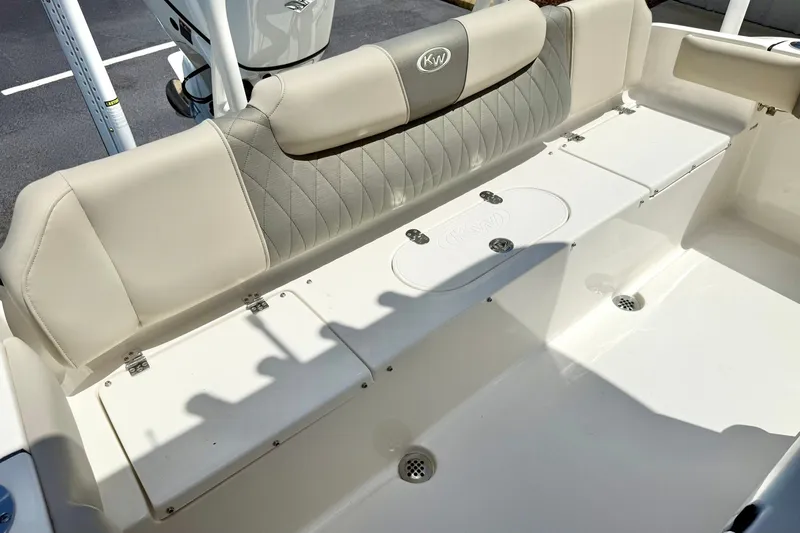 Slide: The Image of 2025 Key West 219 FS boat interior with cushioned seating and storage compartments. - 28