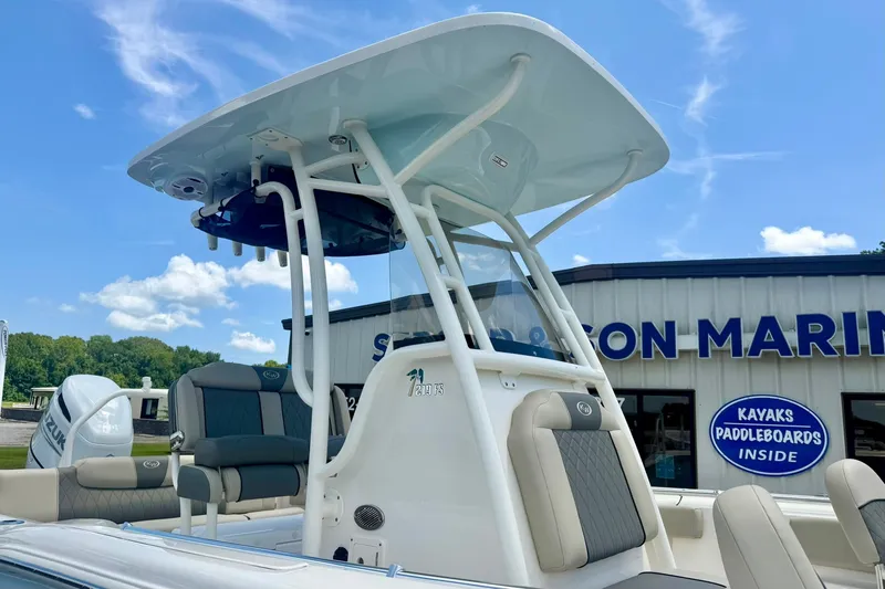 Slide: The Image of 2025 Key West 219 FS boat at a marina, featuring modern seating and canopy. - 34