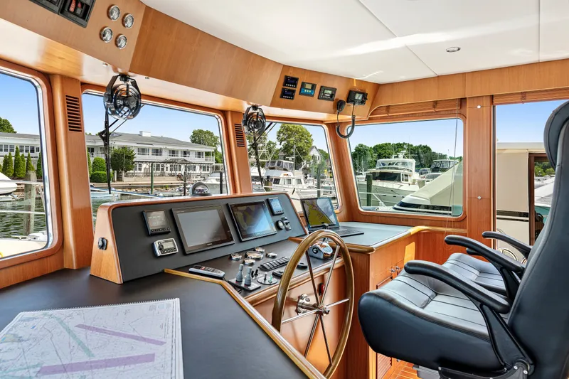 Slide: The Image of Pilothouse interior of 2017 North Pacific 49, featuring navigation equipment and luxurious seating. - 34